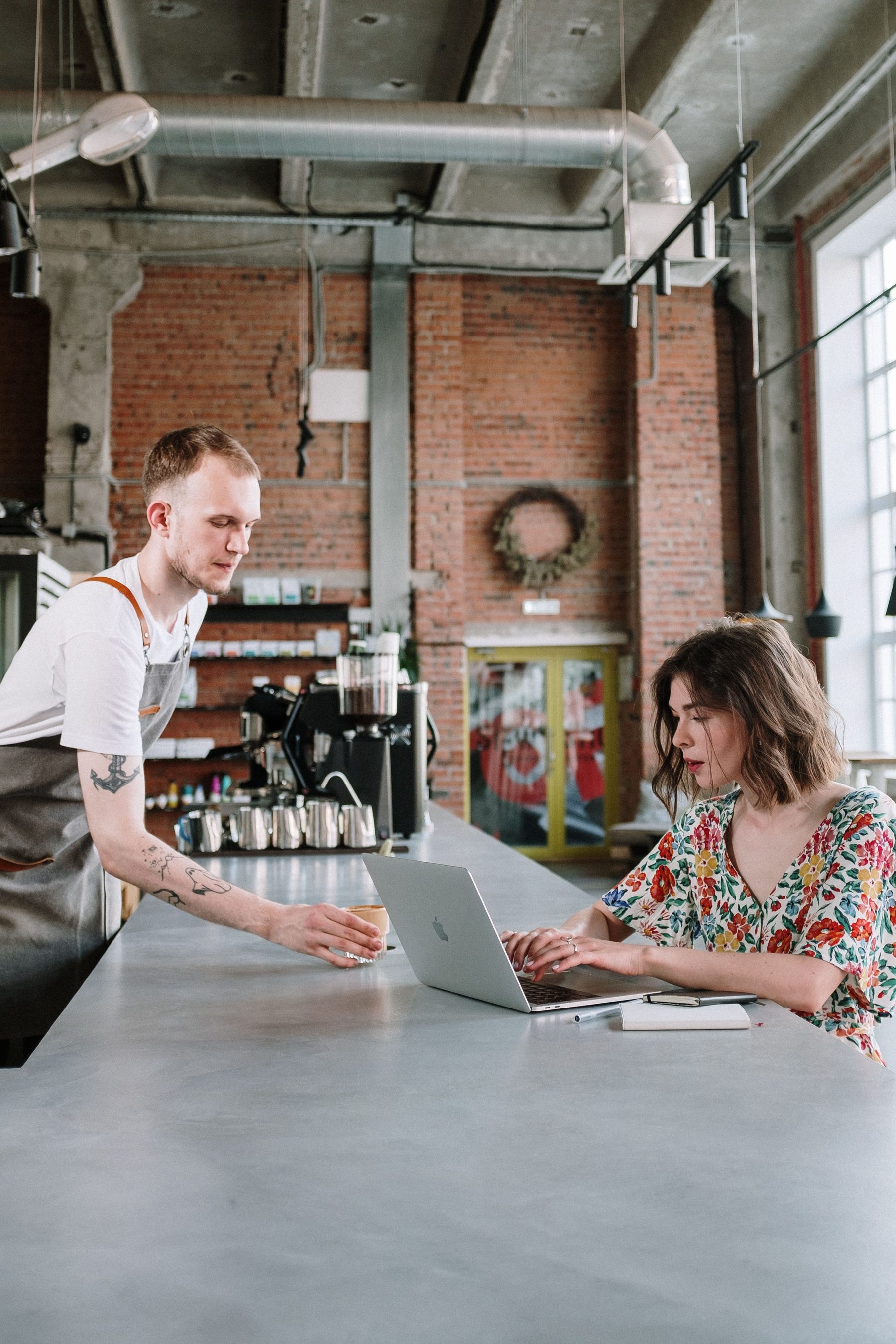 Restaurant operator working from a laptop at a counter