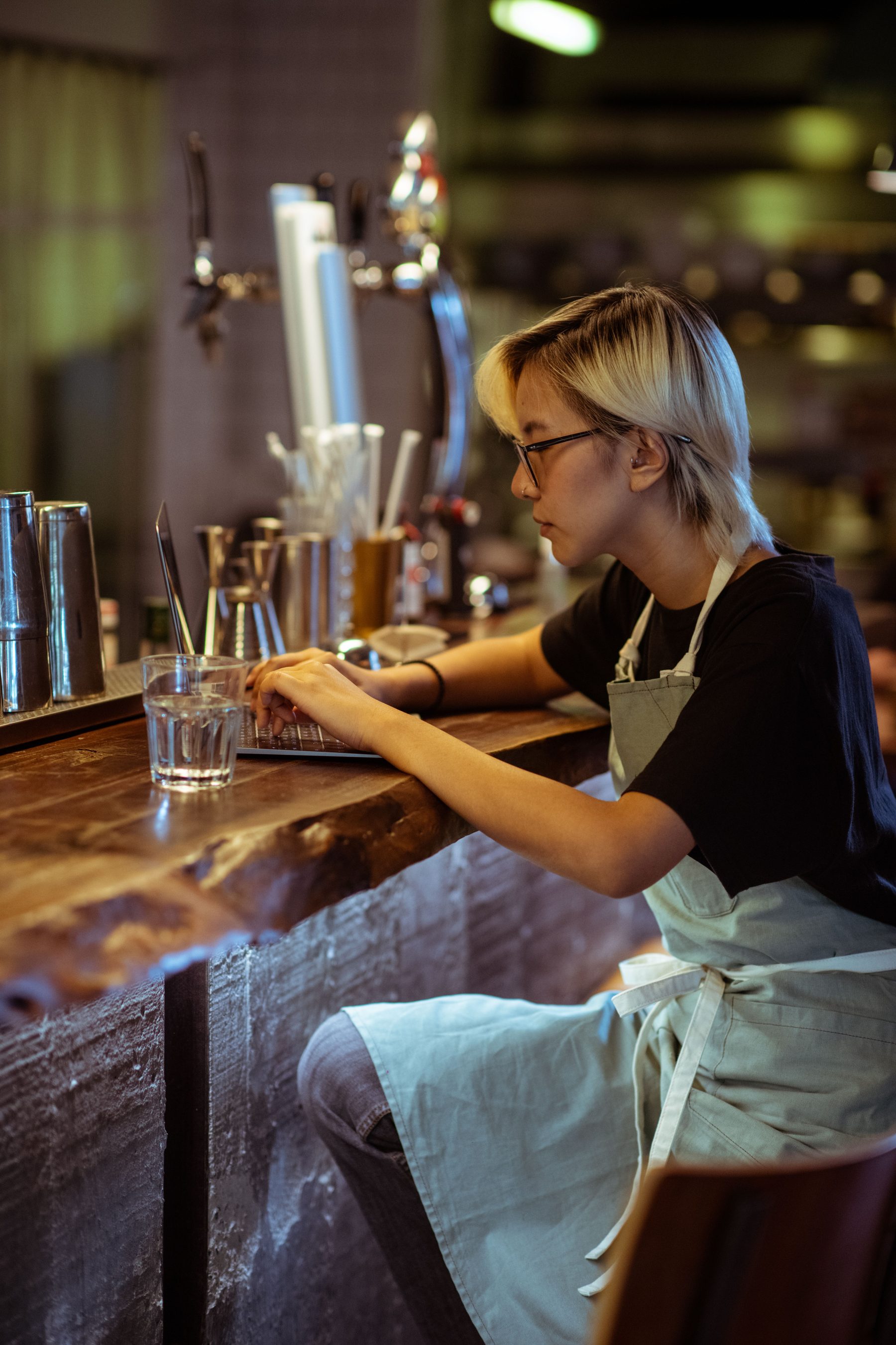 Restaurant operator working from a laptop at the bar
