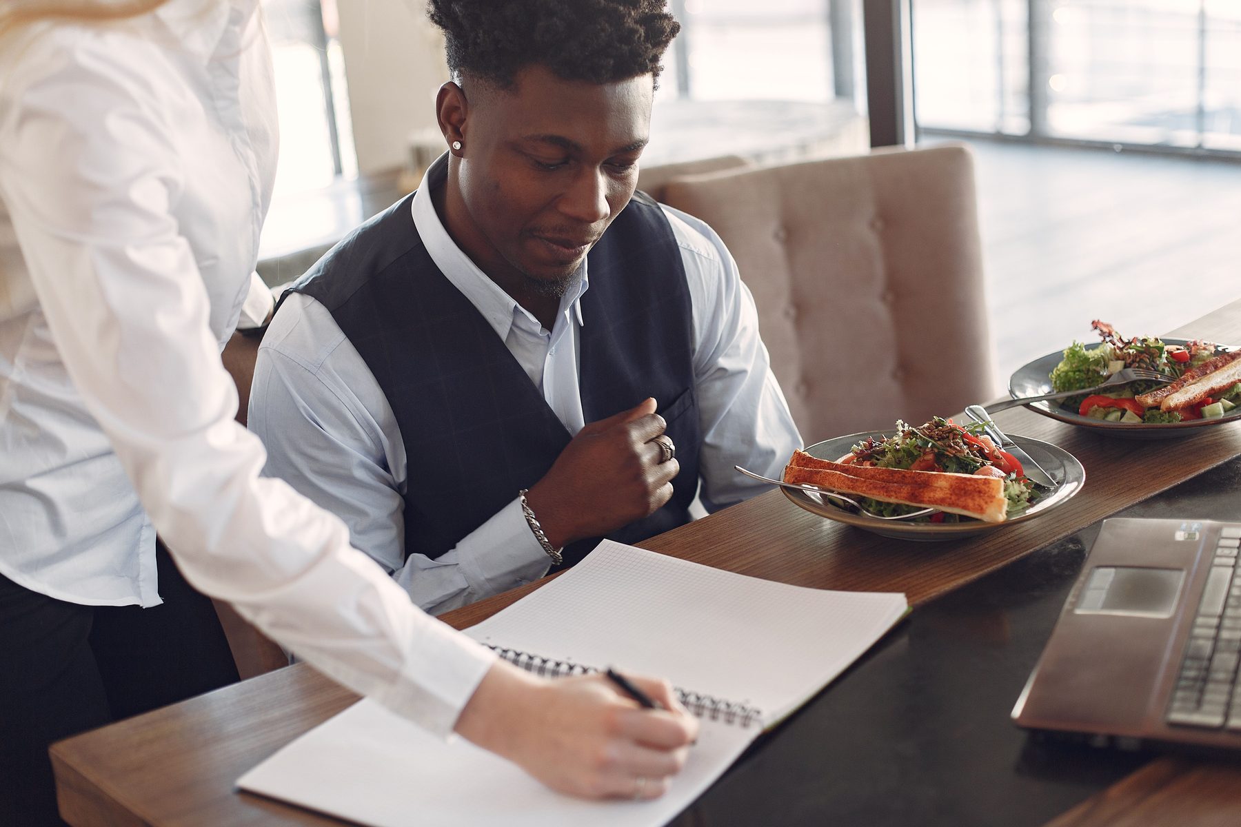 Server reviewing an order with a restaurant guest